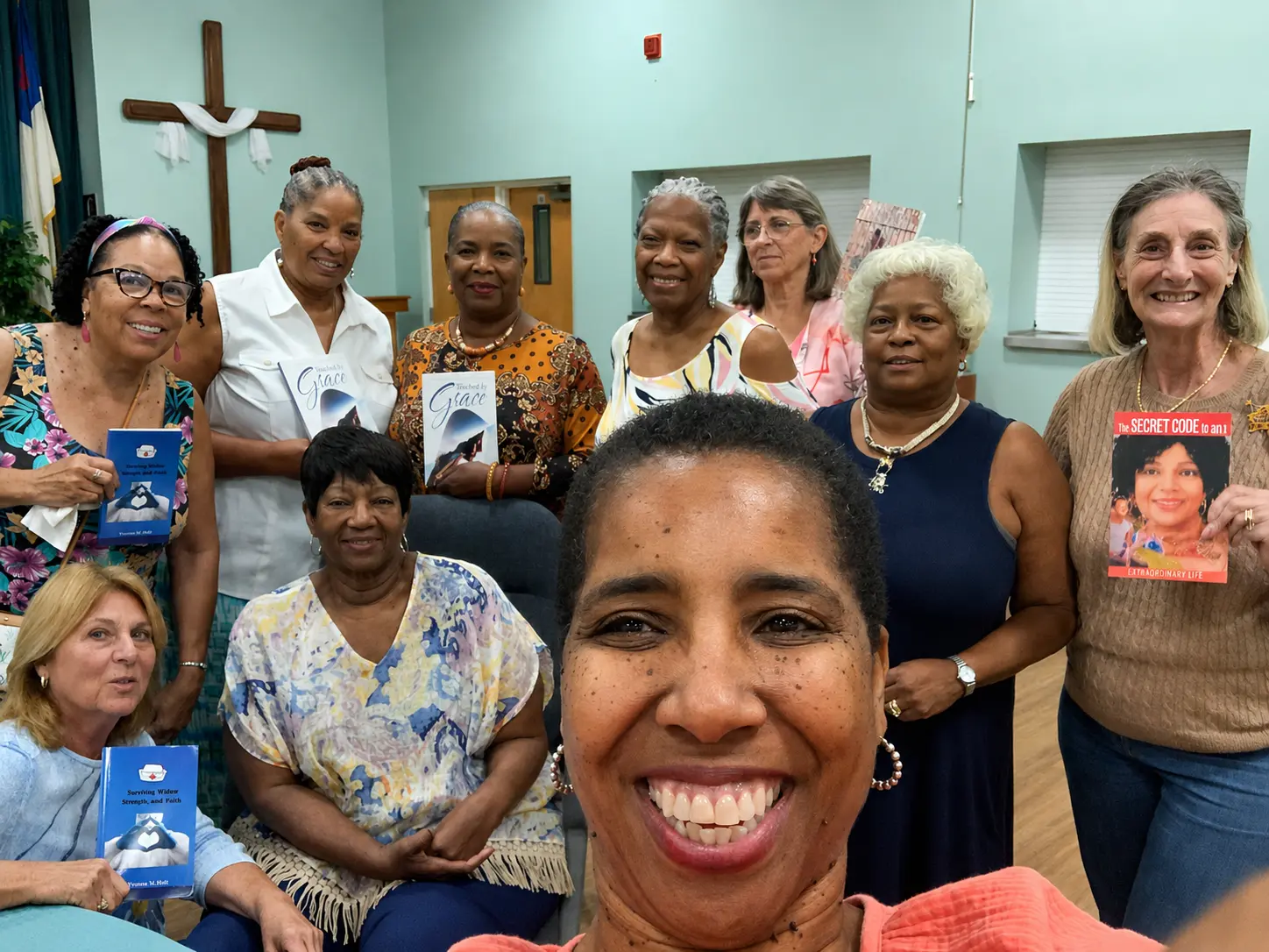 Women sharing books and community stories at a gathering