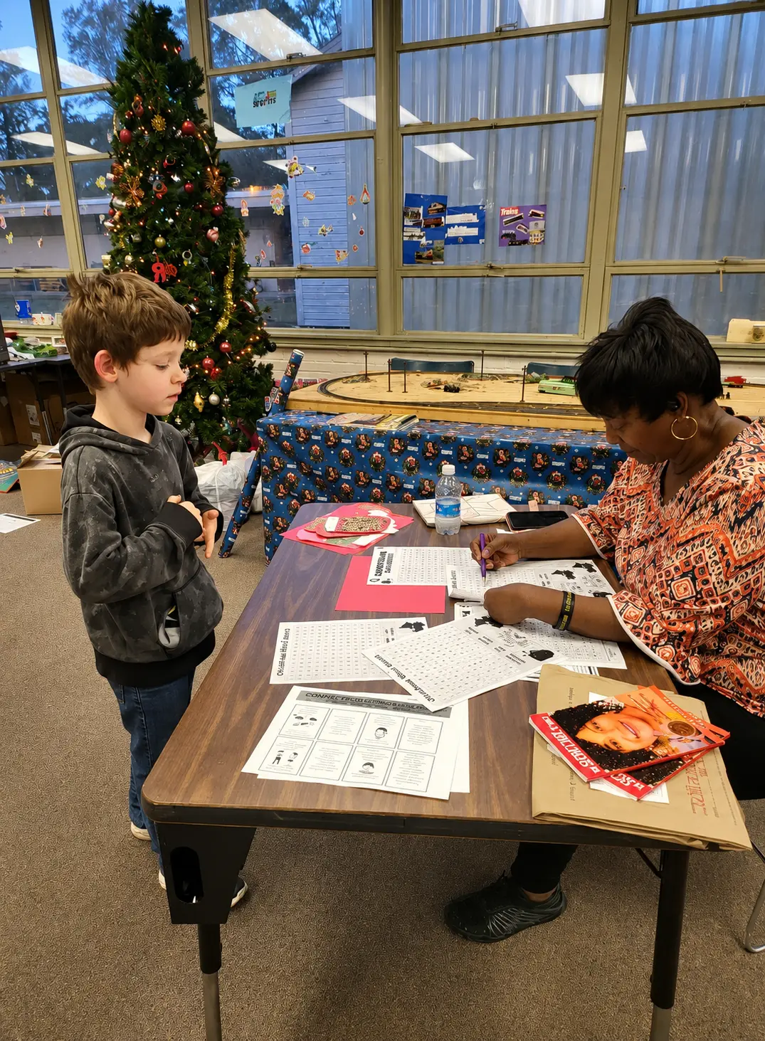 Community volunteer supporting a child’s learning