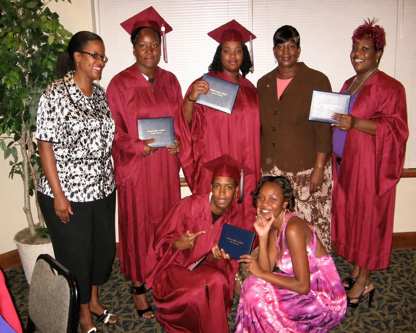 Graduates celebrating achievement with program leaders